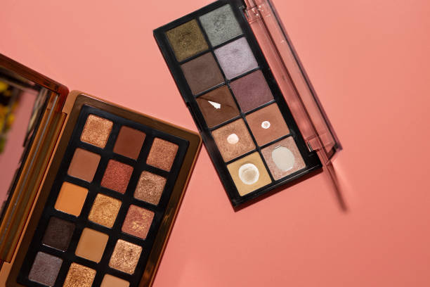 Deep skin tone wearing warm gold, bronze, and jewel-toned eyeshadow shades.