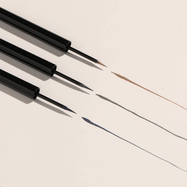 Black, brown, and colored eyeliners arranged together.