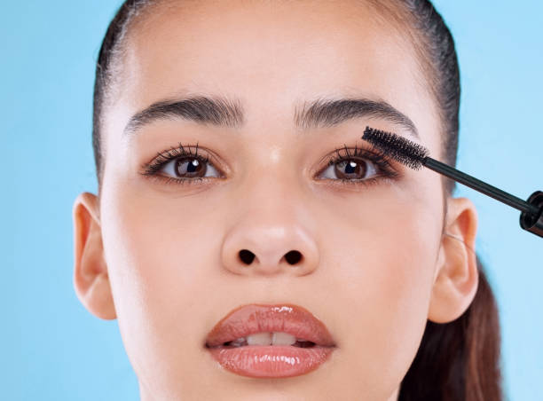 Applying volumizing mascara for fuller lashes.