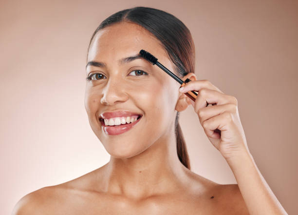 Using mascara on eyebrows for natural enhancement.