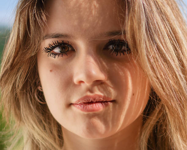 a woman with clean , smudge proof mascara after a long day